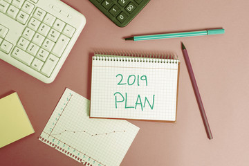 Word writing text 2019 Plan. Business photo showcasing setting up your goals and plans for the current year or in 2019 Writing equipments and computer stuffs placed above classic wooden table