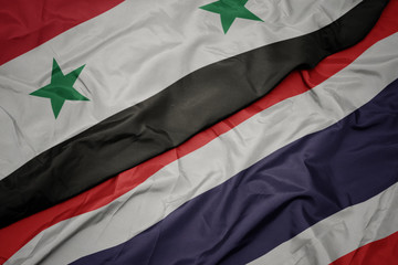 waving colorful flag of thailand and national flag of syria.