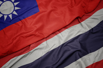 waving colorful flag of thailand and national flag of taiwan.