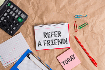 Writing note showing Refer A Friend. Business concept for direct someone to another or send him something like gift Papercraft desk square spiral notebook office study supplies