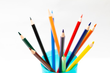 color pencils in a cup on white background