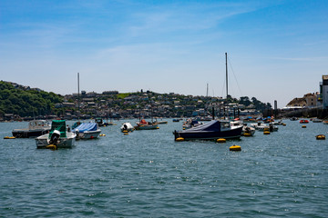 Fototapeta na wymiar Pleasure boats moored on the River Fowey estuary in Cornwall