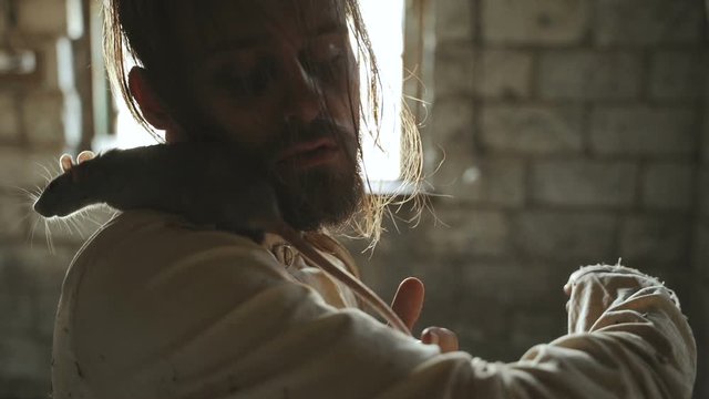 Crazy Terrible Maniac In Basement With Window Playing With Rat