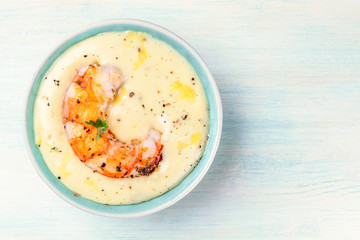 A fried shrimp with a dip, a seafood appetizer, shot from above with a place for text