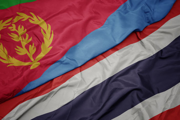 waving colorful flag of thailand and national flag of eritrea.