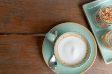 Hot coffee latte  and rock sugar brown on wood table. Top view.