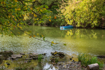 beautiful autumn landscape with a boat by the river