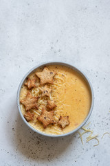 Cheese soup with star toasts on a table