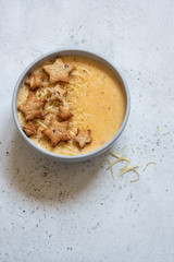 Cheese soup with star toasts on a table