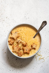 Cheese soup with star toasts on a table