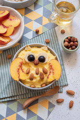 Kids breakfast polenta porridge with fruit look like a cute owl