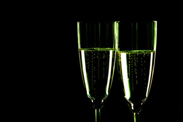 Glasses with champagne on black background, New Year background