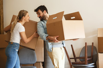 Young married couple moving into new home.They unpacking and cleaning . 