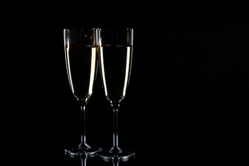 Glasses with champagne on black background, New Year background