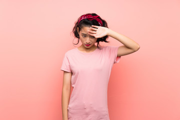 Asian young woman over isolated pink background with tired and sick expression