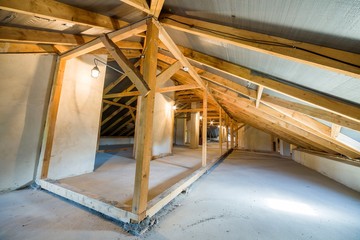 Fototapeta premium Attic of a building with wooden beams of a roof structure.