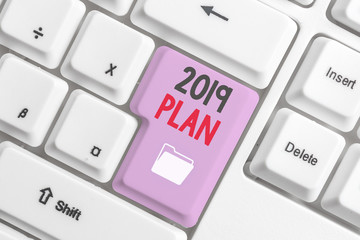 Handwriting text 2019 Plan. Conceptual photo setting up your goals and plans for the current year or in 2019 White pc keyboard with empty note paper above white background key copy space