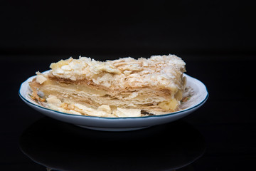 Napoleon cake on a fine ceramic plate