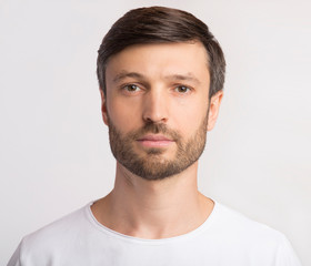 Portrait Of Man Looking At Camera Over White Background