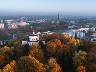 Aerial view of beautiful fall foliage and the Åbo Akademi building on Vartiovuori hill with Turku Cathedral in the background in Turku, Finland