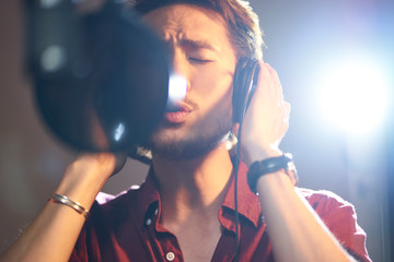 young asian singer singing in recording studio