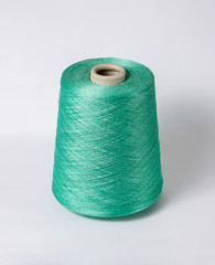 bobbin of yarn on a white background. Side view.Textile reel on isolated white background.