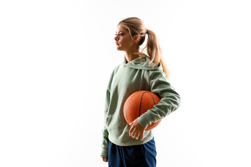 Teenager girl playing basketball over isolated white background