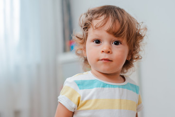 close-up of baby's face, cute baby with curly hair. Portrait of a