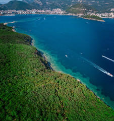 Aerial view of Sveti Nikola, Budva island, Montenegro. Jagged coasts with sheer cliffs overlooking the transparent sea. Wild nature and Mediterranean maquis