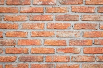 Orange brick wall concrete or stone texture background, wallpaper limestone abstract to flooring and homework/Brickwork or stonework clean grid uneven interior rock old.