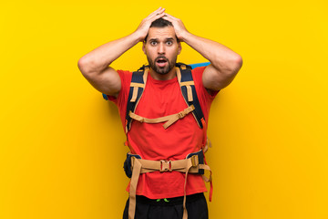 Young hiker man with surprise facial expression