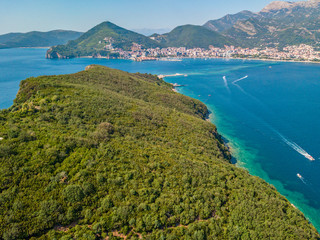 Naklejka premium Aerial view of Sveti Nikola, Budva island, Montenegro. Jagged coasts with sheer cliffs overlooking the transparent sea. Wild nature and Mediterranean maquis