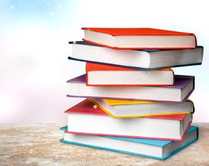 Colorful books collection on classroom background