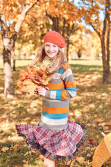 autumn portrait of cute girl in  red hat and coat