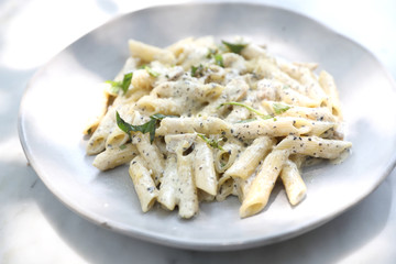 Penne pasta with white sauce and truffle , italian food
