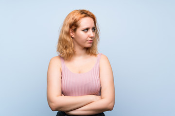 Young woman over isolated blue background portrait
