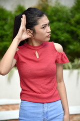 A Cute Filipina Juvenile Listening