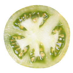 Green tomato cut in half inside cross section isolated on white background