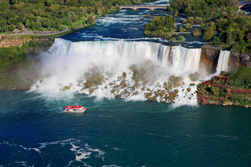 Aerial view of American and Bridal Veil Falls including Hornblower Boat sailing on Niagara River,...