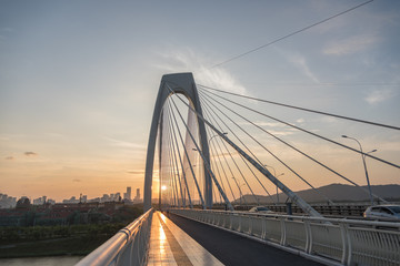 Fototapeta premium Asian city oversized cable-stayed bridge sunset dusk cityscape