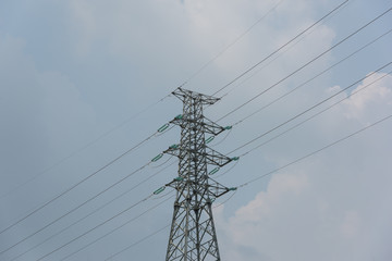 Power transmission tower closeup on blue sky background during daytime
