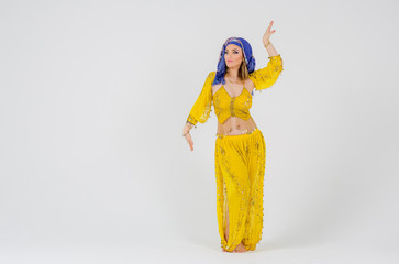 Beautiful woman arabian turkish oriental in carnival yellow costume