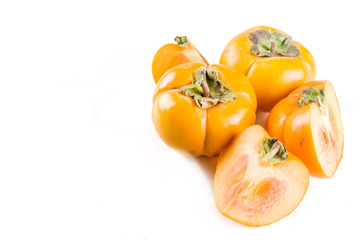 Whole and sliced persimmons, fresh organic farm fruit on a white background. Isolated, copy space