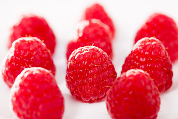handful of raspberry berries on white background