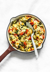 Vegetarian casserole ratatouille, baked in a frying pan on a light background, top view