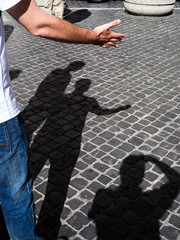 Shadows of men on the road