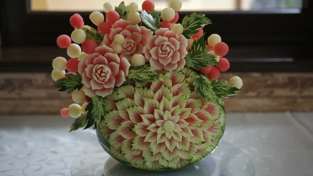 Carving on a watermelon. A cut flower on a watermelon.