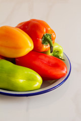 colorful bell peppers on a  white plate