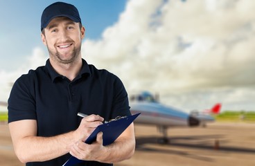 Delivery man with clipboard on light background