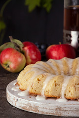 Iced sugar cake with apples on tray, cooper teapot, jars of sorbet